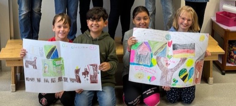 Children from 4b with their pictures for the partner school